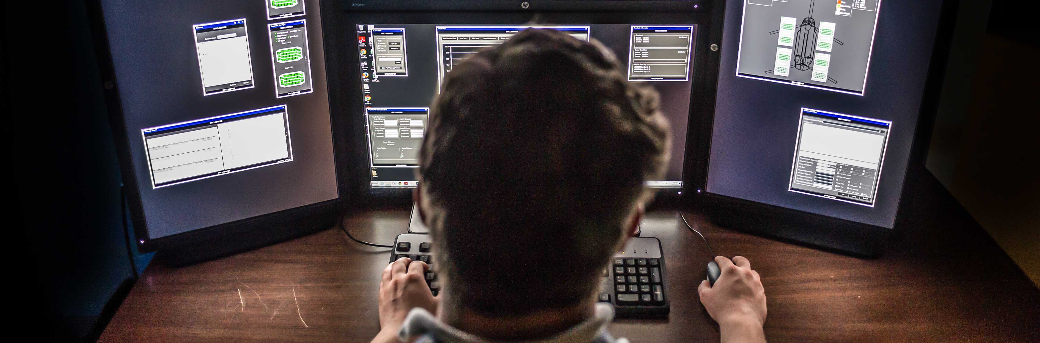 GTRI employee in front of monitors