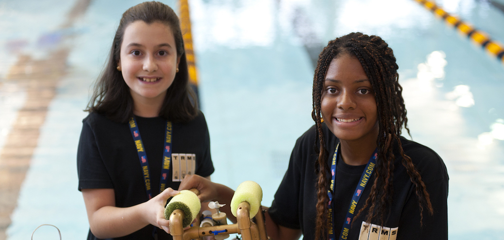 Two students pose with underwater robot