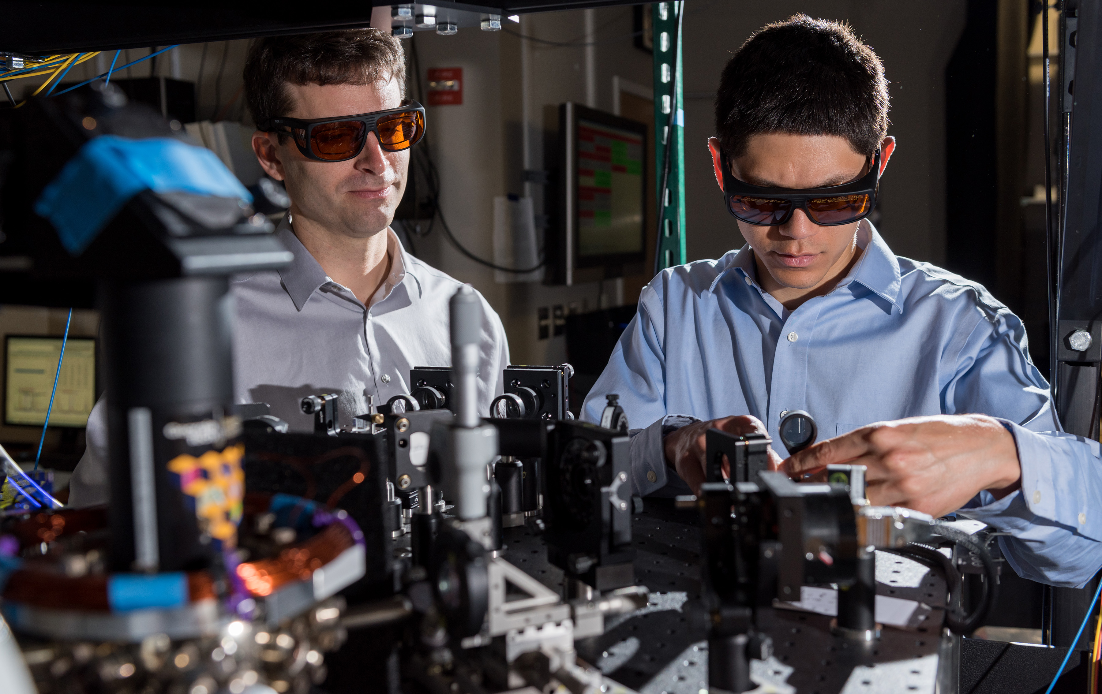 GTRI scientists work in an optical lab developing improved ion traps that could be used in quantum computing. Shown, from left, are research scientists Jason Amini and Nicholas Guise. (Credit: Rob Felt)