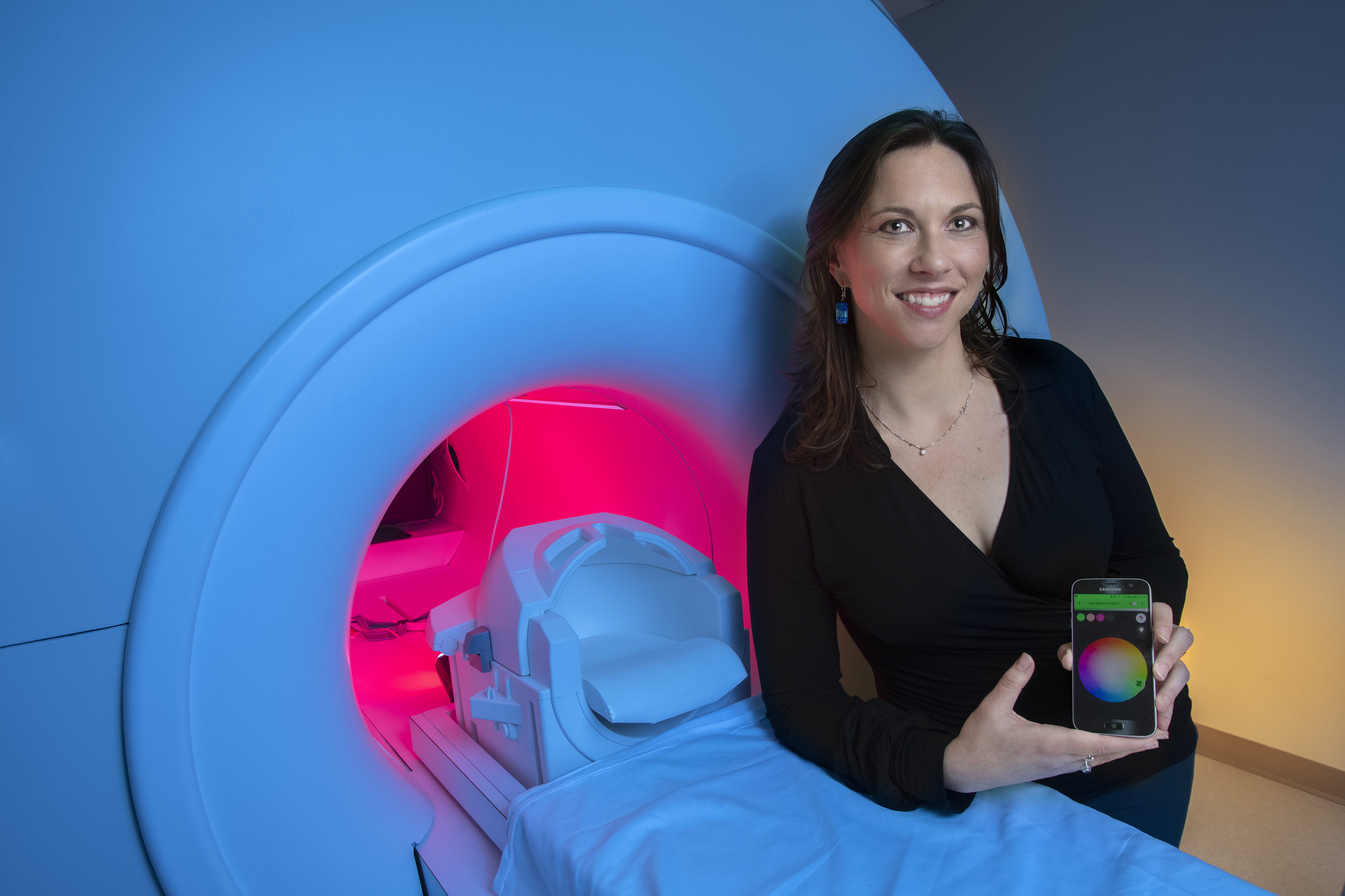 GTRI-Research-Associate-Megan-Denham-shows-a-smartphone-app-that-controls-lighting-around-an-MRI-simulator