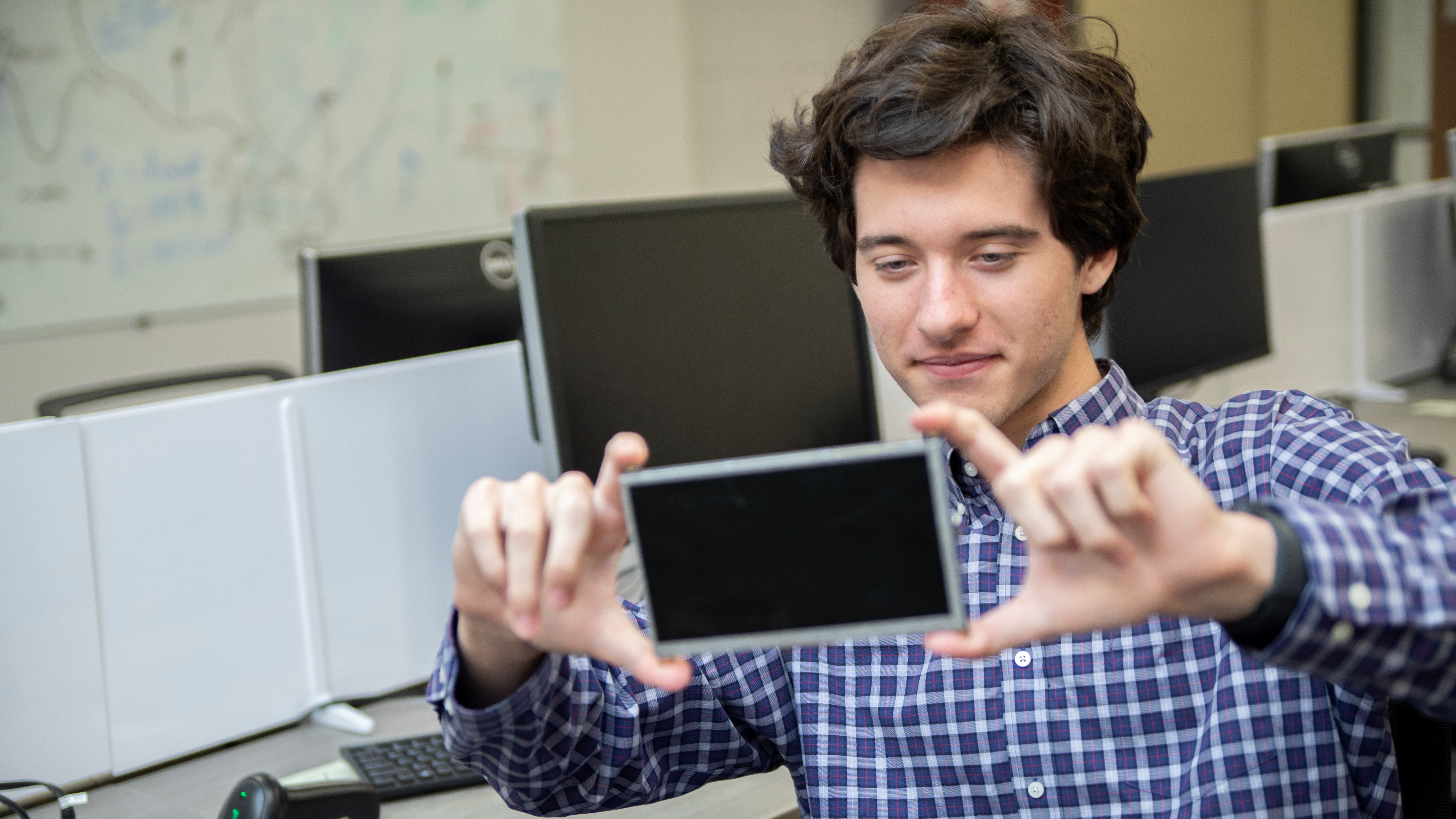 A high school summer intern works on a project in a lab (Photo credit: Christopher Moore).