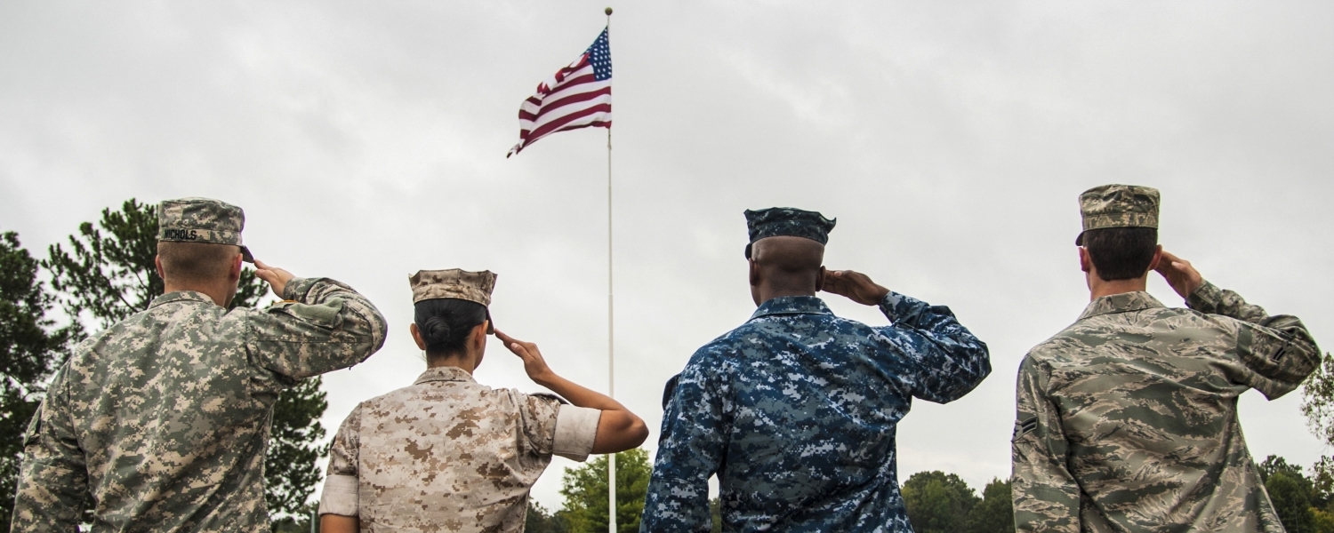 Soldiers saluting the American flag. 