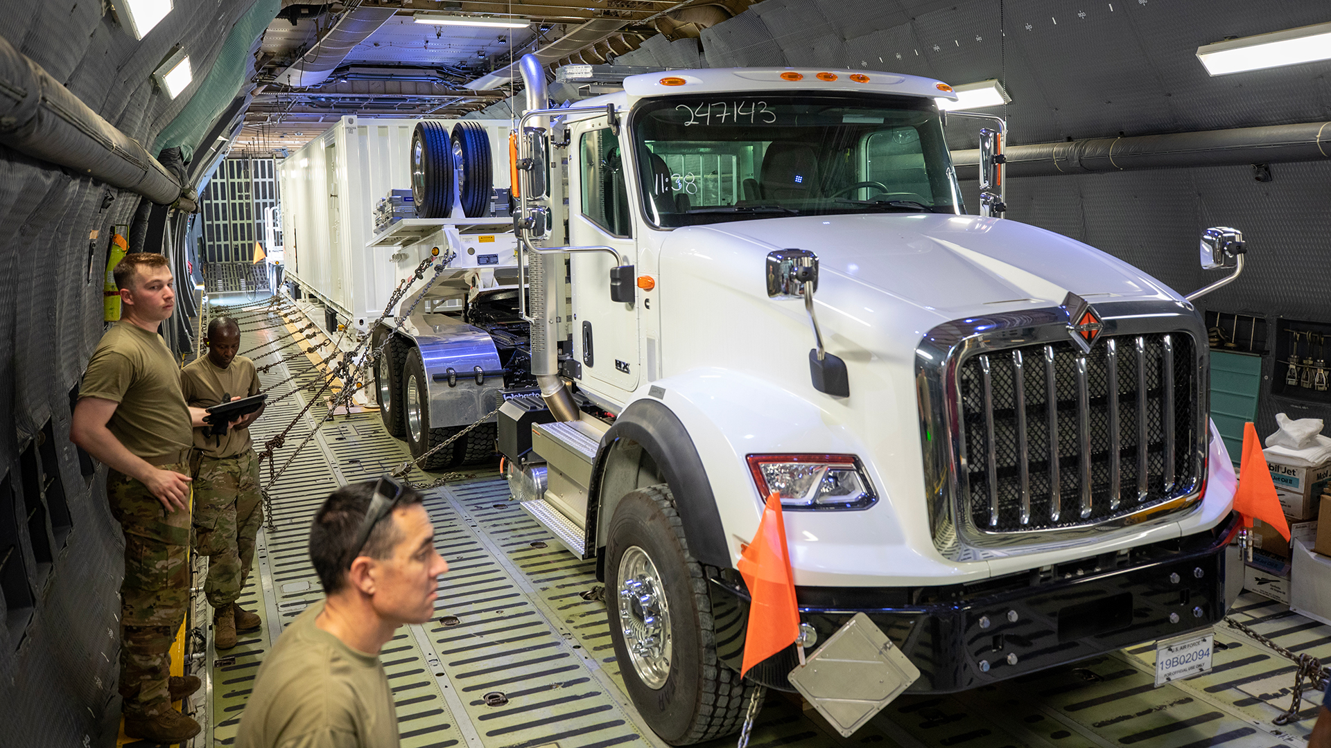 Semi truck and tractor trailer containing ARTS-V1 system sitting inside the body of a large aircraft.